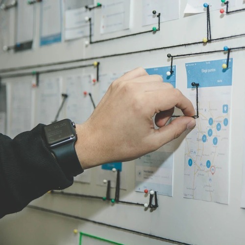 pinning a piece of paper on a board