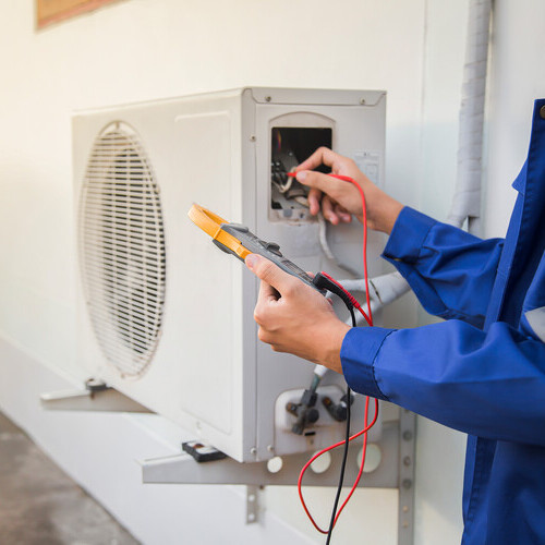 technician checking an air conditioning unit