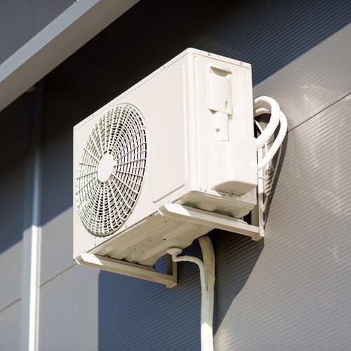 outdoor air conditioning unit against a wall