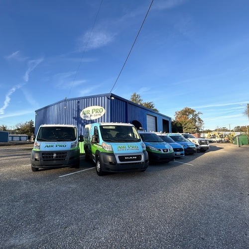 HVAC company vans sitting outside of a trailer