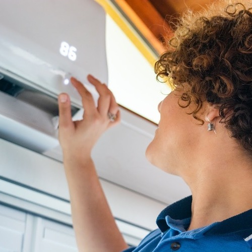 technician checking a mini split AC system